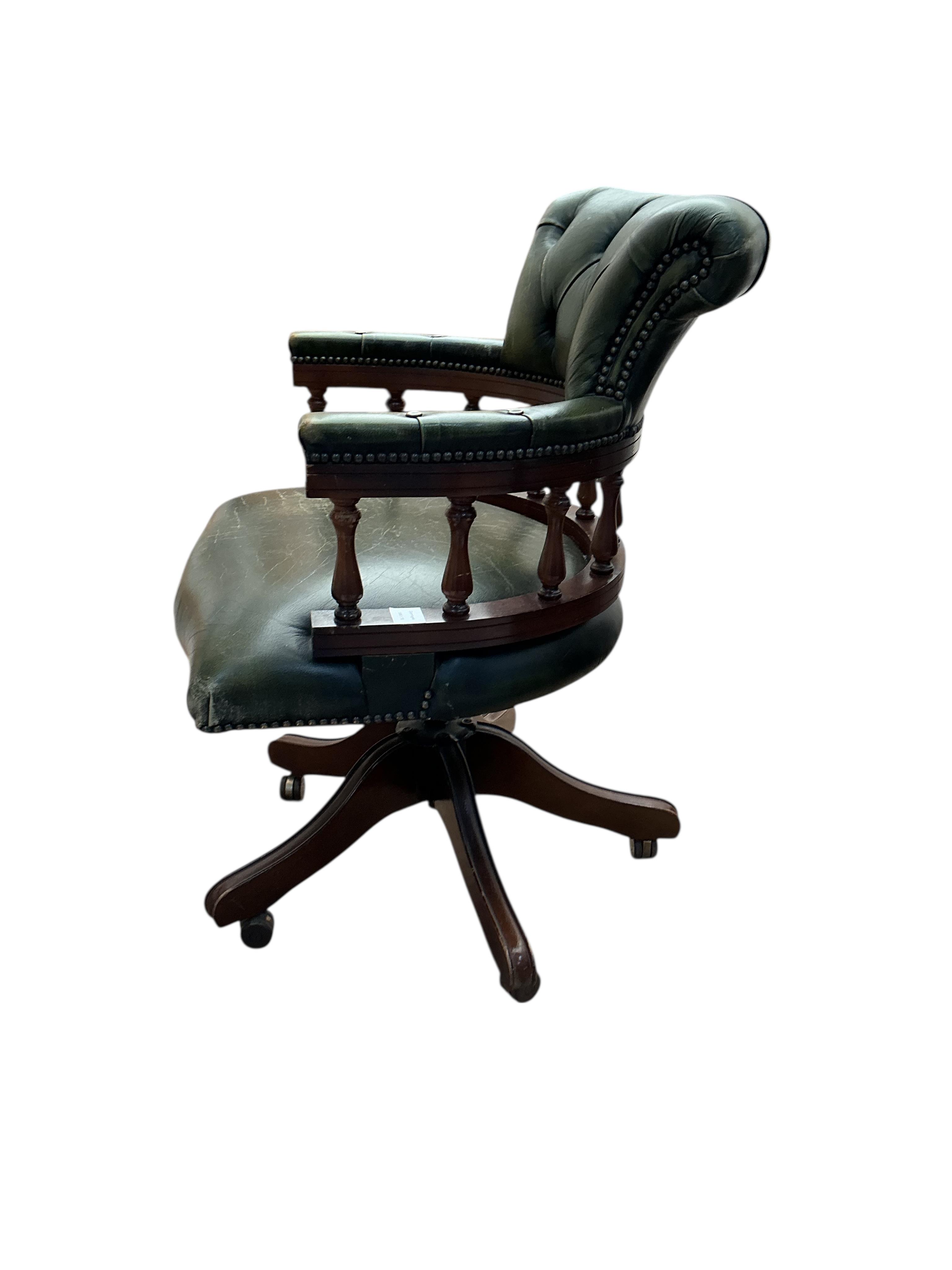 A reproduction buttoned green leather beech swivel desk chair, width 61cm, depth 54cm, height 88cm